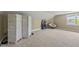 An attic area with neutral walls and carpet, a decorative screen, and a unique chair at 209 Brookberry Rd, Holly Springs, NC 27540