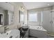 Contemporary bathroom with a double sink vanity, a walk-in shower, and a luxurious soaking tub at 209 Brookberry Rd, Holly Springs, NC 27540