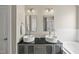 Modern bathroom featuring double sinks, a walk-in shower, and a soaking tub at 209 Brookberry Rd, Holly Springs, NC 27540