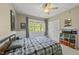 Comfortable bedroom with carpet, a ceiling fan, a large window, and a closet at 209 Brookberry Rd, Holly Springs, NC 27540