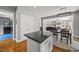 Open kitchen with center island flowing into dining area and view of the living room at 209 Brookberry Rd, Holly Springs, NC 27540