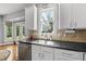 Bright kitchen features a stainless steel sink, ample counter space, and modern appliances at 209 Brookberry Rd, Holly Springs, NC 27540