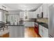 Well-lit kitchen with stainless steel appliances, a center island, and hardwood floors at 209 Brookberry Rd, Holly Springs, NC 27540