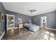 Spacious main bedroom featuring hardwood floors, neutral walls, and plenty of natural light at 209 Brookberry Rd, Holly Springs, NC 27540