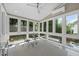 Bright sunroom with large windows provides ample natural light and views of the surrounding landscape at 209 Brookberry Rd, Holly Springs, NC 27540