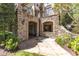 Stunning backyard with stone arches, patio, landscaping, and upper-level balcony at 2117 Buckingham Rd, Raleigh, NC 27607