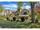 Landscaped backyard with lush lawn, mature trees, privacy hedges, and multi-story home at 2117 Buckingham Rd, Raleigh, NC 27607