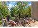 Outdoor balcony features stone pillars and iron railings overlooking lush greenery and lawn at 2117 Buckingham Rd, Raleigh, NC 27607