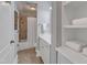 Bathroom featuring a shower-tub combo with tile surround, white vanity, and built-in shelves at 2117 Buckingham Rd, Raleigh, NC 27607