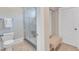 Bright bathroom with glass-enclosed shower, tiled flooring, and modern fixtures at 2117 Buckingham Rd, Raleigh, NC 27607