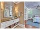 Charming bathroom vanity with mosaic tile and decor next to an open bedroom with star-themed ceiling at 2117 Buckingham Rd, Raleigh, NC 27607