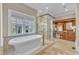 Luxurious bathroom featuring a soaking tub, a walk-in shower, and custom wood cabinetry at 2117 Buckingham Rd, Raleigh, NC 27607