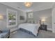Cozy bedroom with hardwood floors, neutral paint, and large windows providing ample natural light at 2117 Buckingham Rd, Raleigh, NC 27607