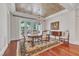 Formal dining room with hardwood floors, chandelier, and French doors to outdoor space at 2117 Buckingham Rd, Raleigh, NC 27607