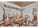 Spacious dining room with hardwood floors, decorative chandelier, and access to the living room and staircase at 2117 Buckingham Rd, Raleigh, NC 27607
