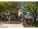 Charming home featuring a stone and stucco exterior, mature trees, and landscaped front yard at 2117 Buckingham Rd, Raleigh, NC 27607