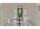 Bright foyer featuring a round table with floral arrangement and a leaded glass window at 2117 Buckingham Rd, Raleigh, NC 27607