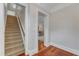 Neutral hallway leads to carpeted stairs with white trim, offering a glimpse into other rooms at 2117 Buckingham Rd, Raleigh, NC 27607