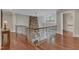 Stunning home hallway with hardwood floors, wrought iron banister, and stone wall accent at 2117 Buckingham Rd, Raleigh, NC 27607