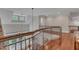 Elegant hallway with hardwood floors, detailed railing and stone accent wall, connecting various levels at 2117 Buckingham Rd, Raleigh, NC 27607