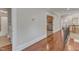Hallway with hardwood floors, stairs, and views to the bathroom, kitchen, and living room at 2117 Buckingham Rd, Raleigh, NC 27607
