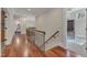 Hallway with hardwood floors, stairs, and views to the office and living room at 2117 Buckingham Rd, Raleigh, NC 27607