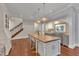 Gourmet kitchen with a large island, custom cabinets, professional-grade appliances, and hardwood floors at 2117 Buckingham Rd, Raleigh, NC 27607