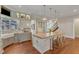 Beautiful kitchen with a farmhouse sink, granite countertops, custom cabinets, and a large island with seating at 2117 Buckingham Rd, Raleigh, NC 27607