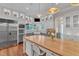 Gourmet kitchen with custom cabinets, a large center island, professional appliances, and hardwood floors at 2117 Buckingham Rd, Raleigh, NC 27607