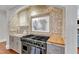 Modern kitchen range with granite countertops, custom cabinets, and a decorative tile backsplash at 2117 Buckingham Rd, Raleigh, NC 27607
