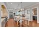 Bright and airy kitchen featuring a large island, custom cabinetry, stainless steel appliances, and hardwood floors at 2117 Buckingham Rd, Raleigh, NC 27607
