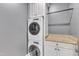 Efficient laundry room with stackable washer and dryer and custom cabinetry for storage at 2117 Buckingham Rd, Raleigh, NC 27607