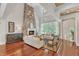 Open-concept living room with a stone fireplace, hardwood floors, and elegant furnishings at 2117 Buckingham Rd, Raleigh, NC 27607
