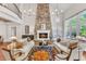 Bright living room featuring a stone fireplace, hardwood floors, and a balcony view at 2117 Buckingham Rd, Raleigh, NC 27607