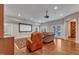 Spacious living room features hardwood floors, projection screen, and comfortable seating with ample light at 2117 Buckingham Rd, Raleigh, NC 27607