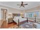 Spacious main bedroom with wood floors, neutral walls, with a large decorative bed and side tables at 2117 Buckingham Rd, Raleigh, NC 27607
