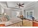 Relaxing bedroom with tray ceiling, ceiling fan, sitting area, and access to the balcony at 2117 Buckingham Rd, Raleigh, NC 27607