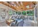Relaxing sunroom with wood ceiling, tile flooring, and plenty of natural light overlooking backyard at 2117 Buckingham Rd, Raleigh, NC 27607