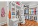 Spacious walk-in closet with custom shelves, drawers, and hanging rods for optimal storage at 2117 Buckingham Rd, Raleigh, NC 27607