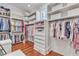 Large walk-in closet featuring custom shelves, drawers, and hanging rods for optimal storage at 2117 Buckingham Rd, Raleigh, NC 27607