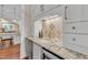 Elegant wet bar with granite countertop, custom cabinets, wine fridge, and stylish backsplash at 2117 Buckingham Rd, Raleigh, NC 27607