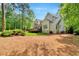 The home features a spacious backyard, with lush trees, a private deck, and a well-maintained lawn at 2201 Avinshire Pl, Wake Forest, NC 27587