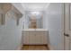 Cozy bathroom features patterned wallpaper, a large mirror, and ample storage at 2201 Avinshire Pl, Wake Forest, NC 27587