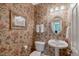 Cozy powder room featuring floral wallpaper, a pedestal sink, and ornate mirror at 2201 Avinshire Pl, Wake Forest, NC 27587