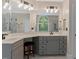 Modern bathroom featuring double sinks, custom cabinets, and a walk-in shower for a spa-like experience at 2201 Avinshire Pl, Wake Forest, NC 27587