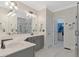 Bright bathroom with double sinks, custom cabinets, walk-in shower, and modern fixtures, offering a luxurious feel at 2201 Avinshire Pl, Wake Forest, NC 27587