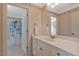 Bathroom featuring a vanity with white countertop, mirror, and view into shower at 2201 Avinshire Pl, Wake Forest, NC 27587