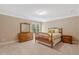 Bright bedroom features neutral walls, plush carpeting and traditional furnishings at 2201 Avinshire Pl, Wake Forest, NC 27587