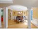 Elegant dining room featuring hardwood floors, decorative columns, and stylish lighting fixture at 2201 Avinshire Pl, Wake Forest, NC 27587