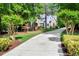 Long driveway leading up to this two-story home surrounded by mature trees at 2201 Avinshire Pl, Wake Forest, NC 27587